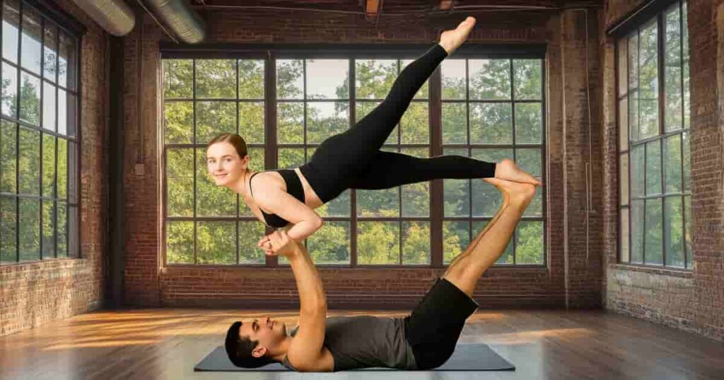 A couple practicing a graceful partner yoga pose indoors, symbolizing trust, balance, and sacred connection in Tantra Yoga.