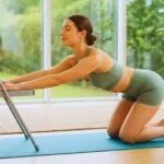 Easy Yoga for Beginners: A peaceful woman demonstrating a gentle seated twist in a chair, showing an accessible way to start a yoga practice at home.